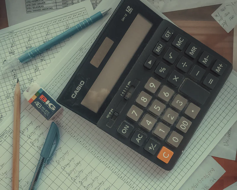 Calculator resting on accounting ledgers
